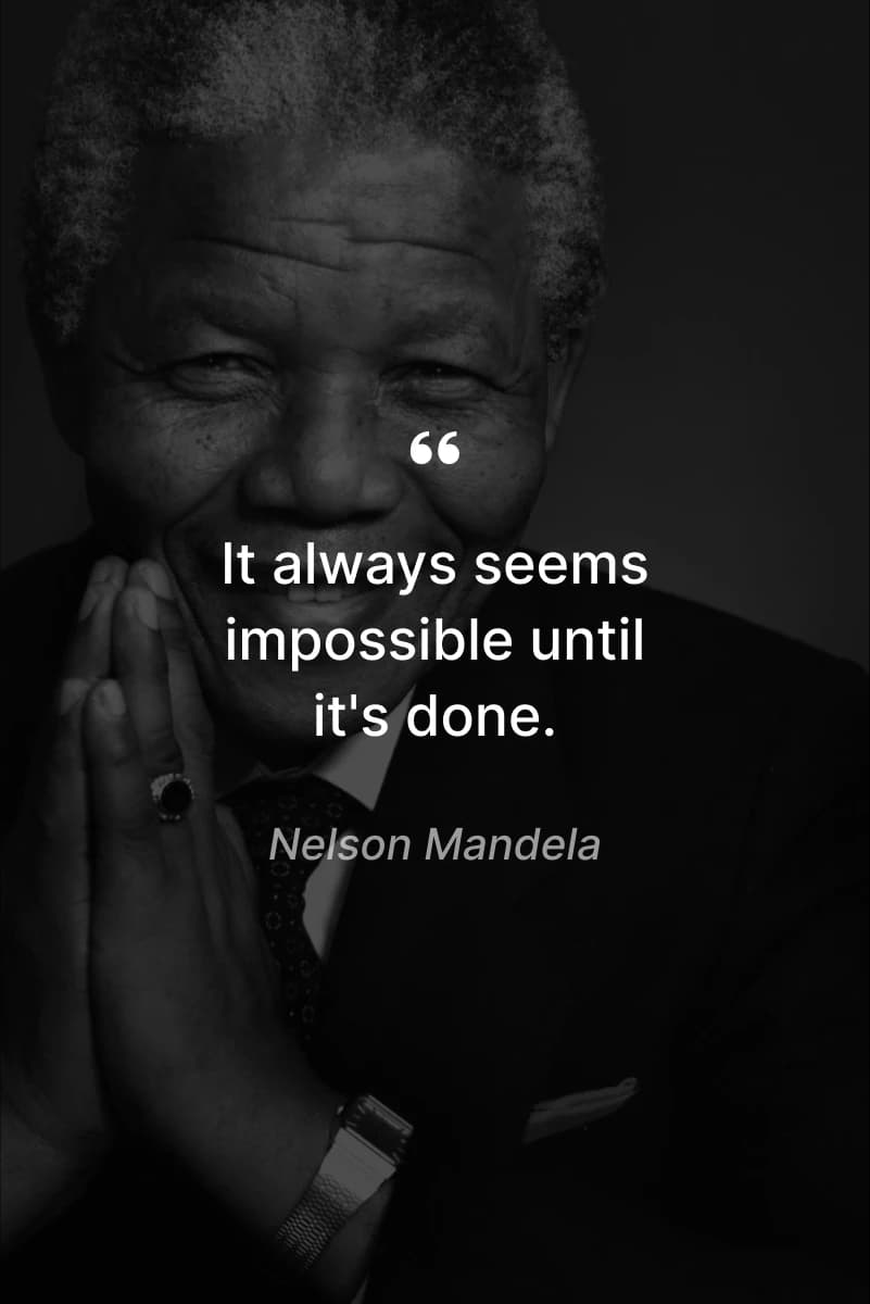 Black-and-white photo of Nelson Mandela smiling with hands clasped in front of him - personal growth